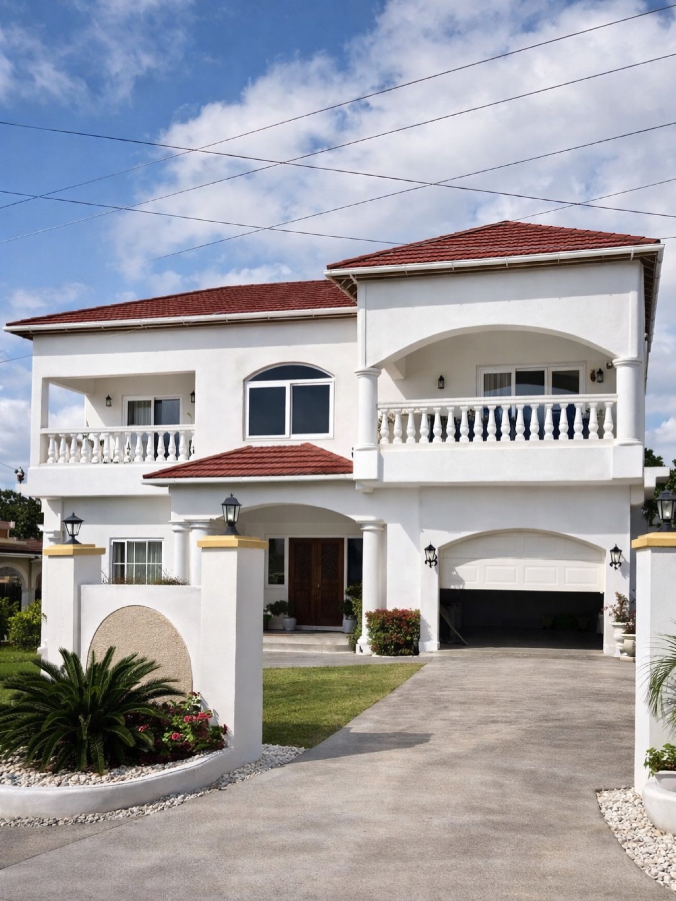 Exterior of a St. Thomas home with white uPVC window and door work shown from the Exquisite Instagram feed.